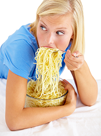 Girl gobbling carbs (spagetti)